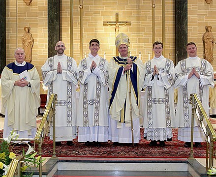 Bishop David M. O'Connell, C.M., ordains four men as transitional deacons