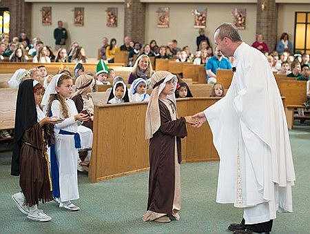 Schoolchildren dress as holy men, women on All Saints' Day