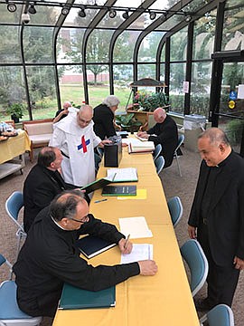 Bishop, diocesan officials review parish registers, records