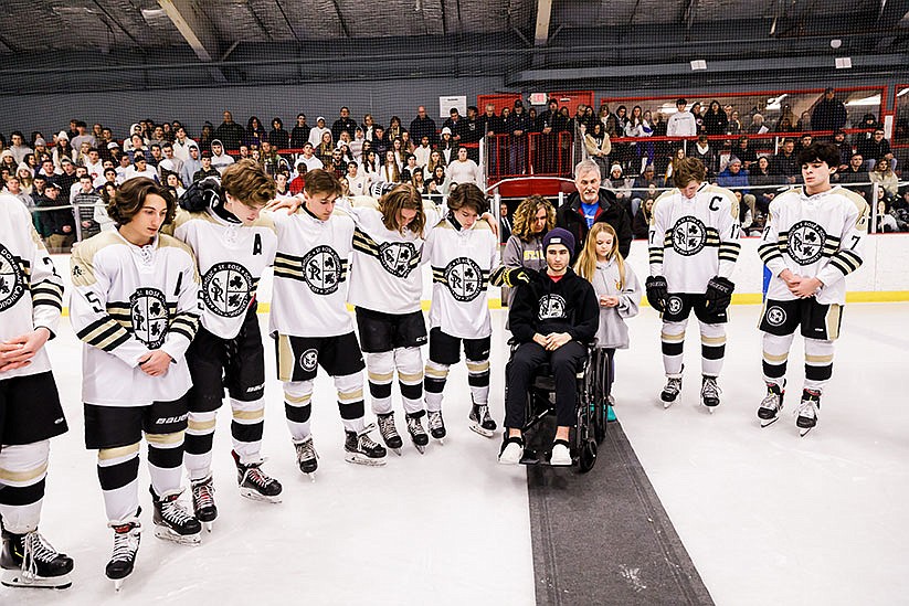 Catholic school hockey players unite in fundraiser for injured St. Rose student