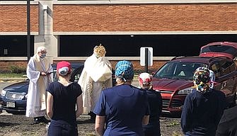 Brick pastors pray with hospital staff on Holy Saturday