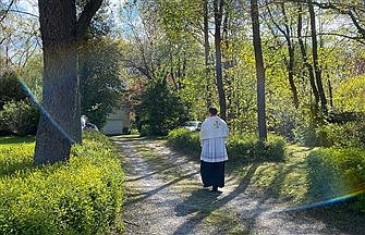 Isolated, those on front lines uplifted as priests bring Blessed Sacrament within monstrance