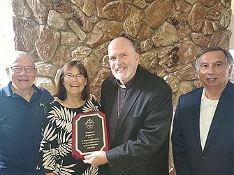 Bishop thanks former diocesan schools superintendent for dedication