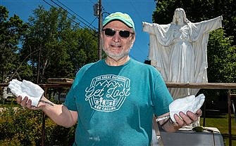 Artist casts his own hands in restoration of Wisconsin parish's statue