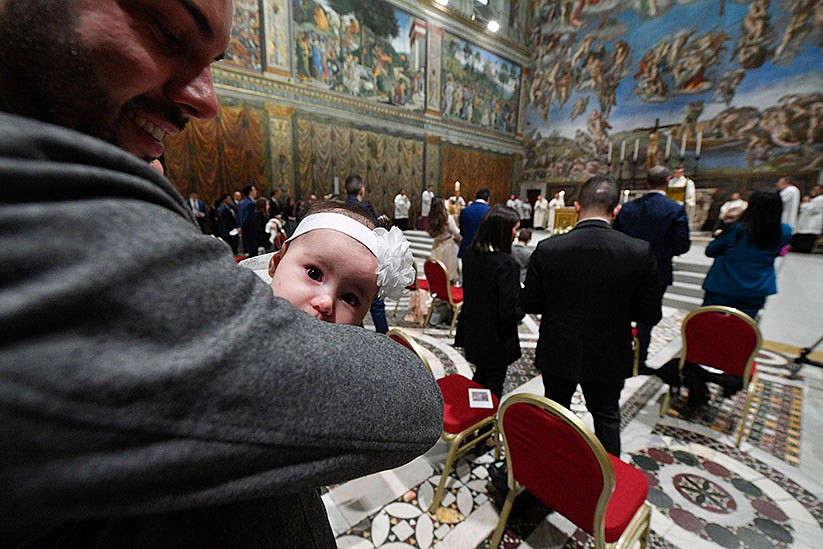 Pope baptizes babies, urges parents to teach them to pray